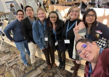 MAST Dept. students smiling at a conference.