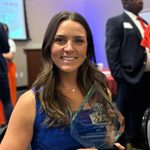 Alyssa Svalberg holding her 2024 Alumni Volunteer of the Year award