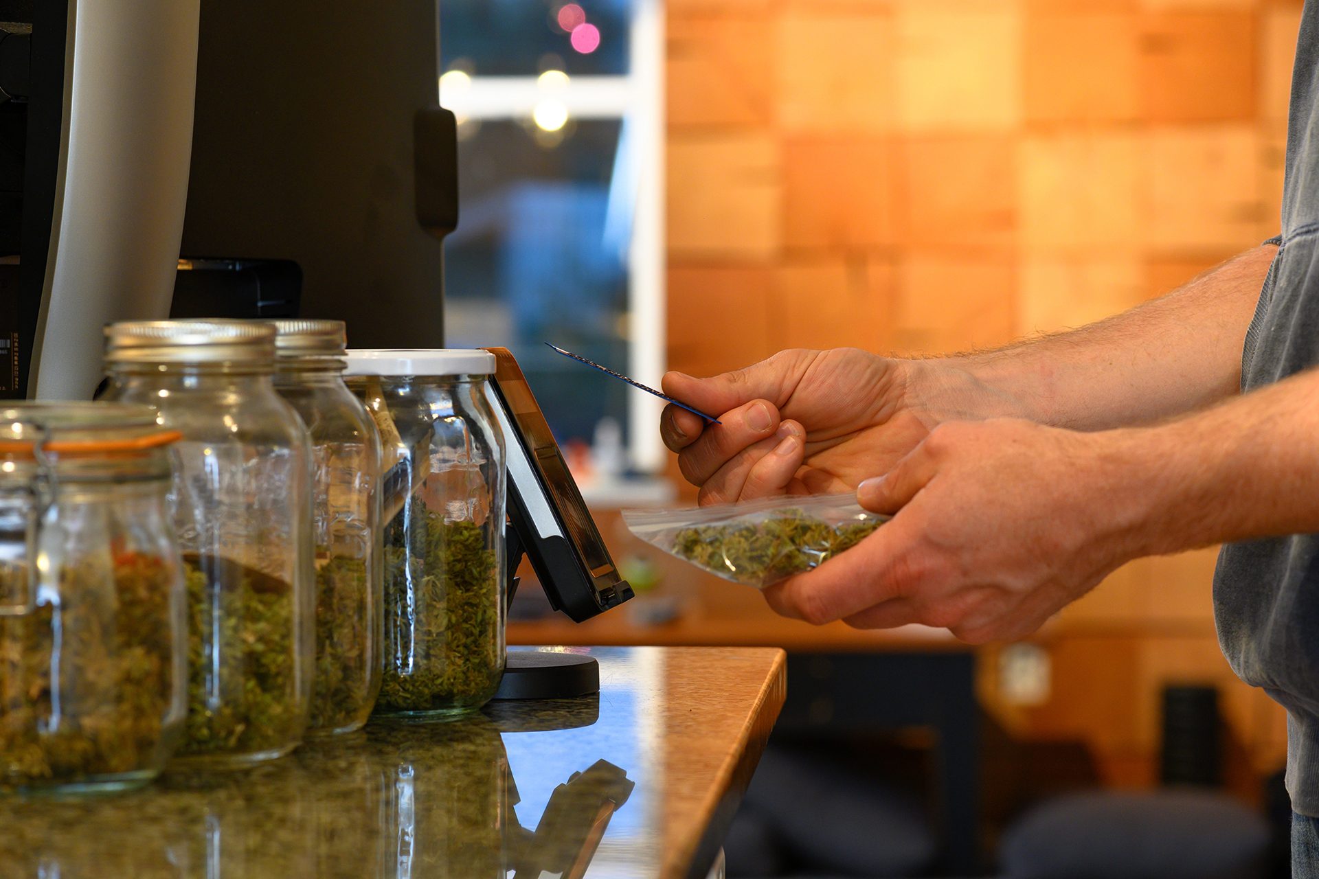 Person paying for cannabis in a dispensary
