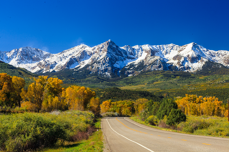 Photo of road leading into mountains