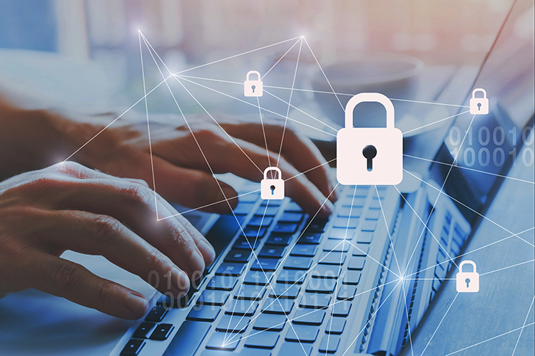 closeup of hands typing on a laptop with padlocks and code appearing over the image