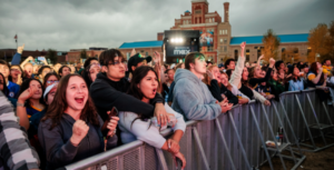 people smiling and cheering while watching a concert at MSU Denver