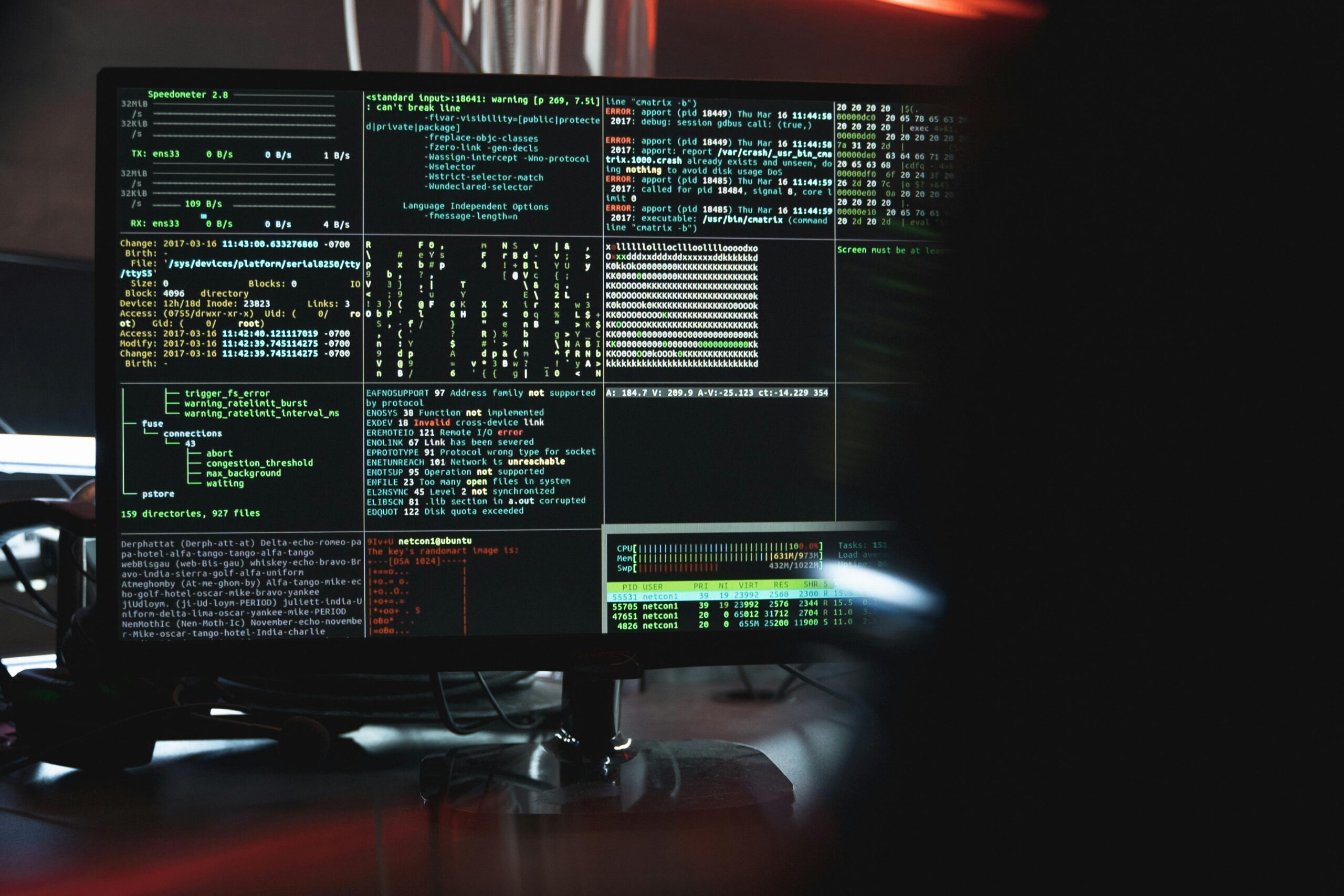 A photo of a computer screen displaying data in a dark room.
