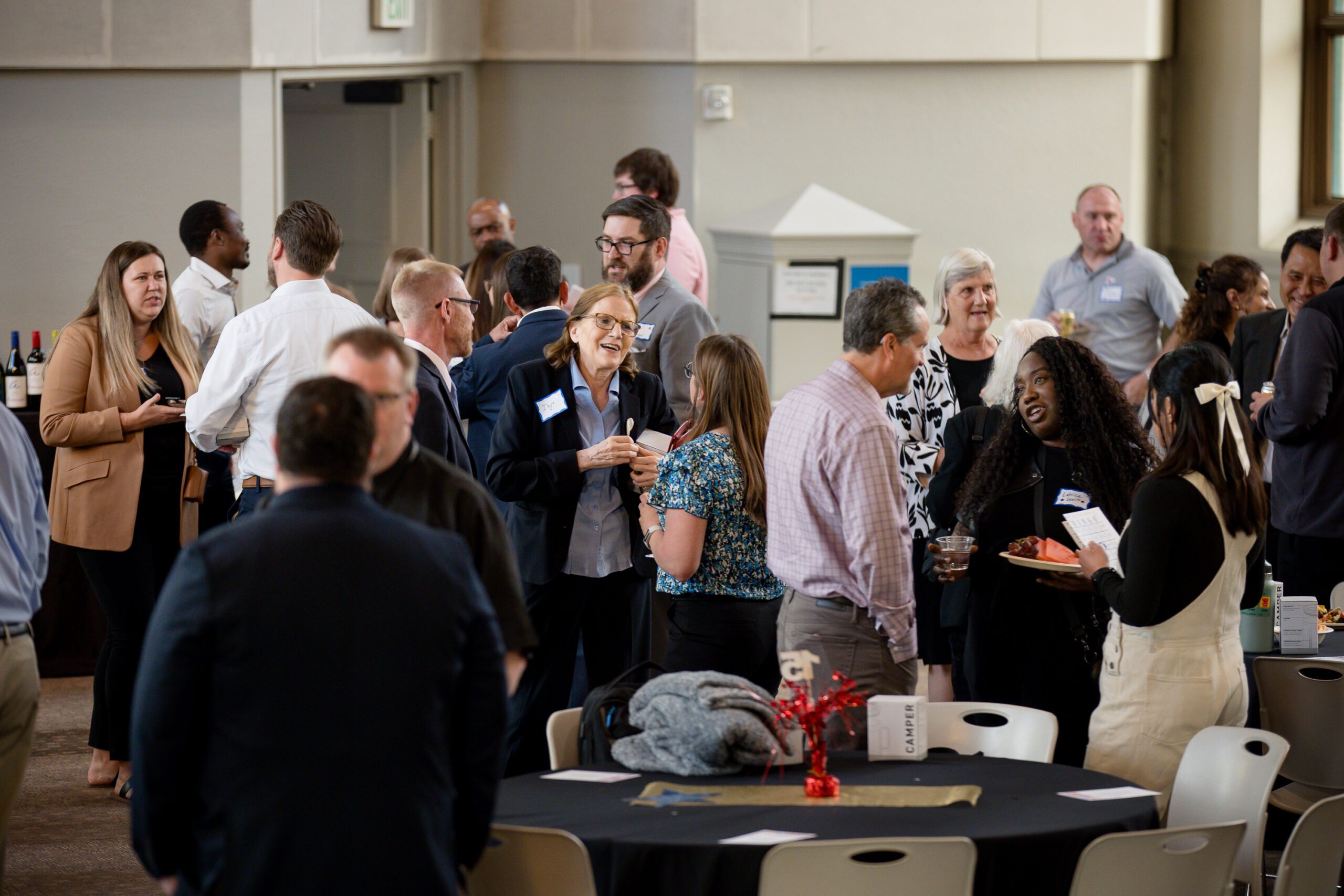 MPAcc's 15 year anniversary event - crowd of attendees socializing before program begins