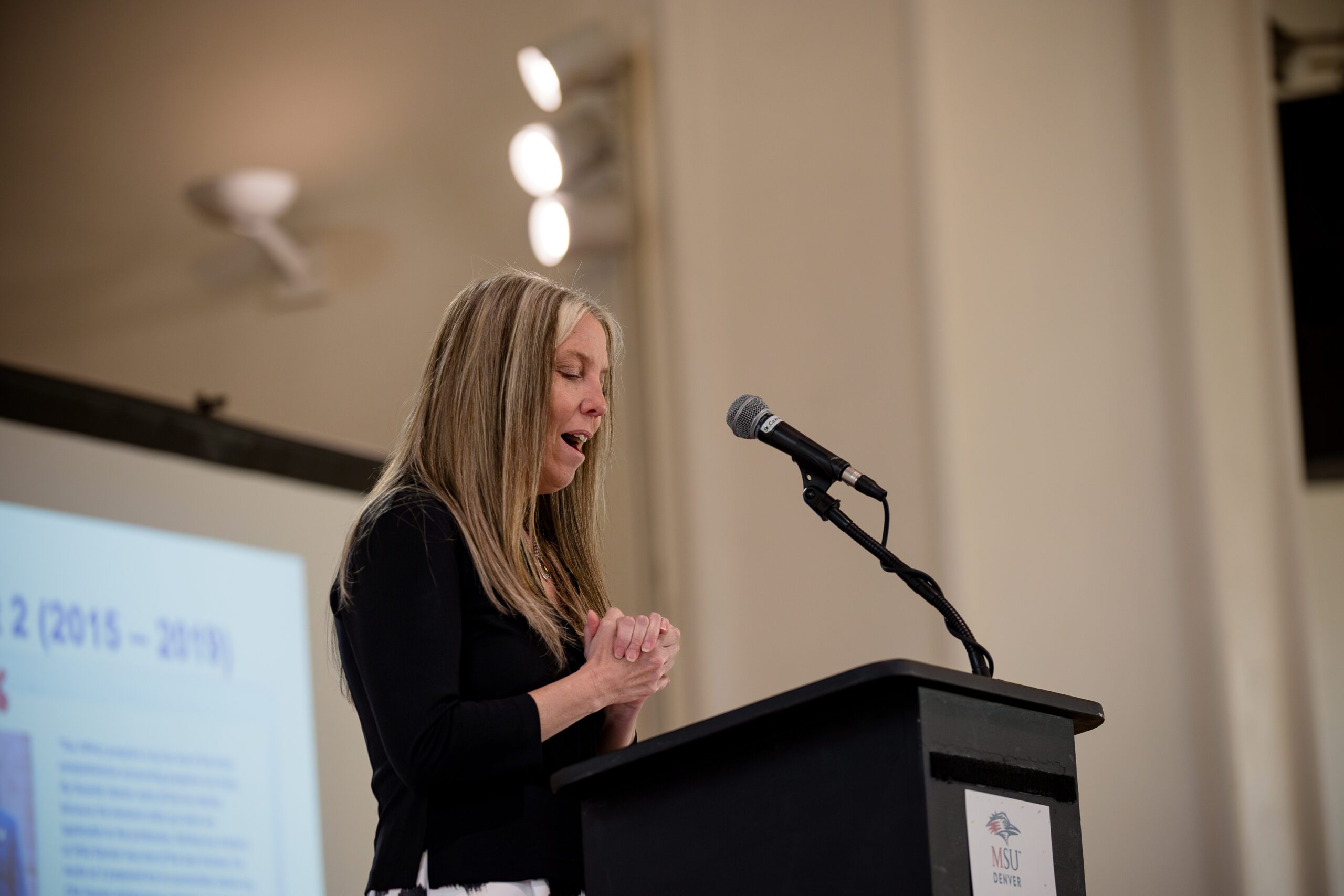 Amy Cardillo, MPAcc faculty & alum, talking at the podium during MPAcc's 15 year anniversary event