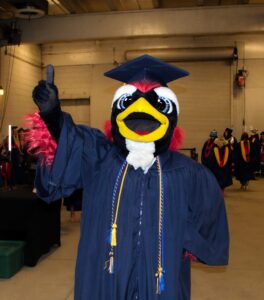 Spring 2025 Commencement Ceremony - Rowdy in full regalia posing for the camera before the event