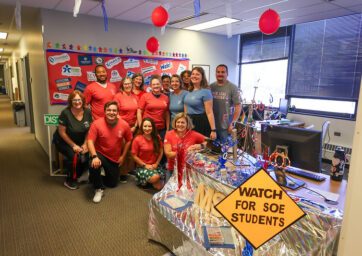 Staff members pose in a group during Homecoming 2024 Office Decorating Contest