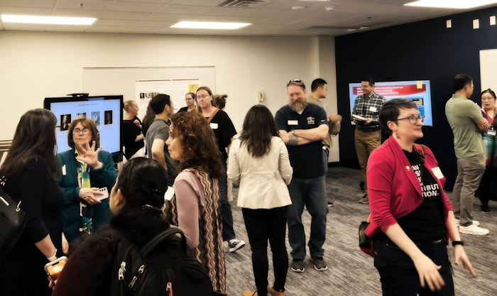 Folks gathered in a classroom chatting with each other for the CTLD Celebration of Faculty 2024