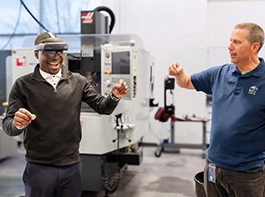 MSU Denver student Faisal Kaweesa and instructor Stephen Morgan use augmented reality headsets to practice precision measurement skills in a training simulation. Photo by Josh Geurink