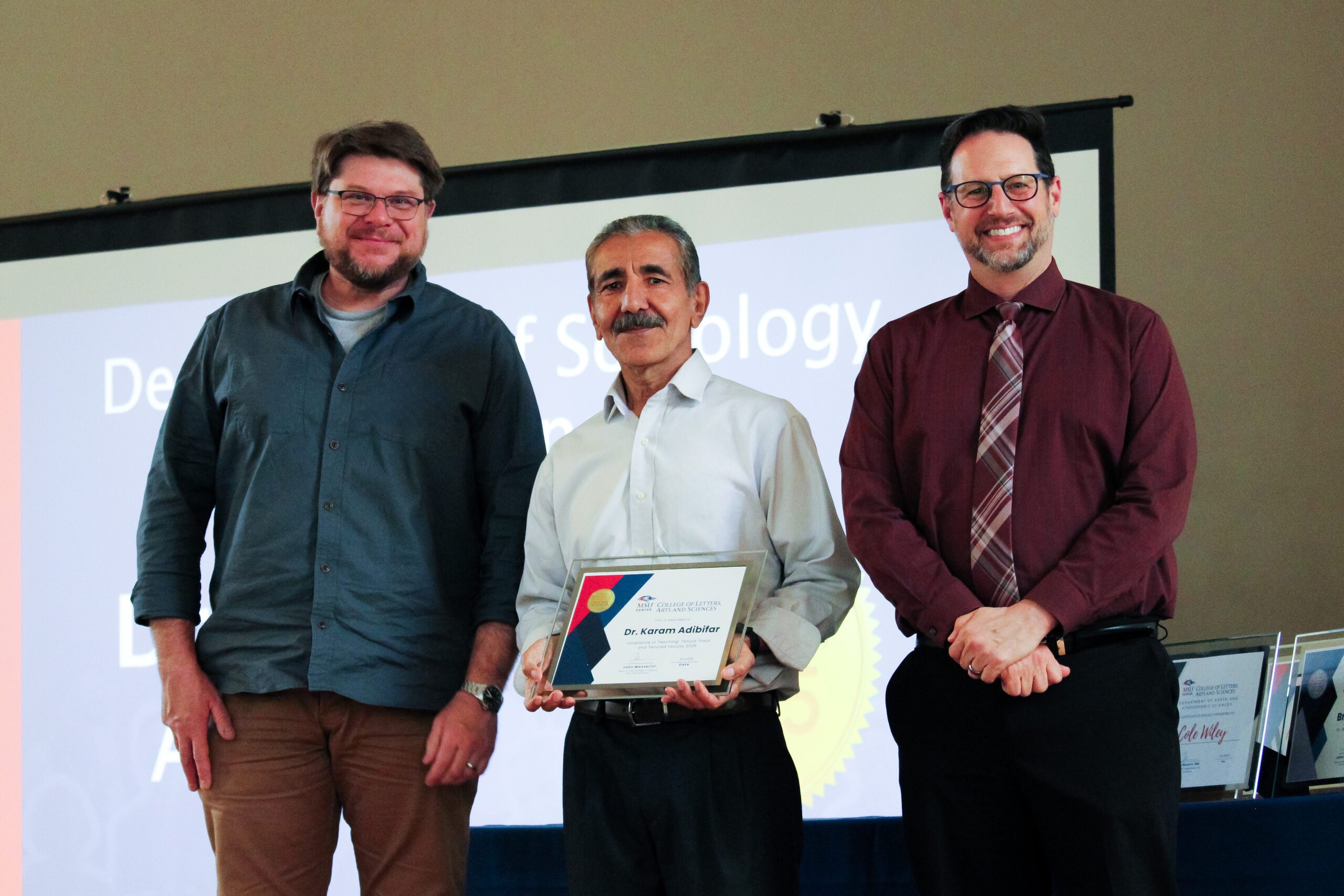 Dr. Karam Adibifar receiving the 2025 CLAS Excellence in Teaching Award. Pictured from left to right: Dr. Todd Yokley, Associate Chair of Sociology and Anthropology; Dr. Karam Adibifar, Award Recipient; and Dr. John Masserini, CLAS Dean.