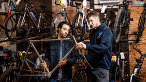 MSU Denver senior Marco Antonacci, left, and Z Cycle Shop co-owner Daniel Spicher discuss a bike frame in Spicher's shop. Photo by Alyson McClaran