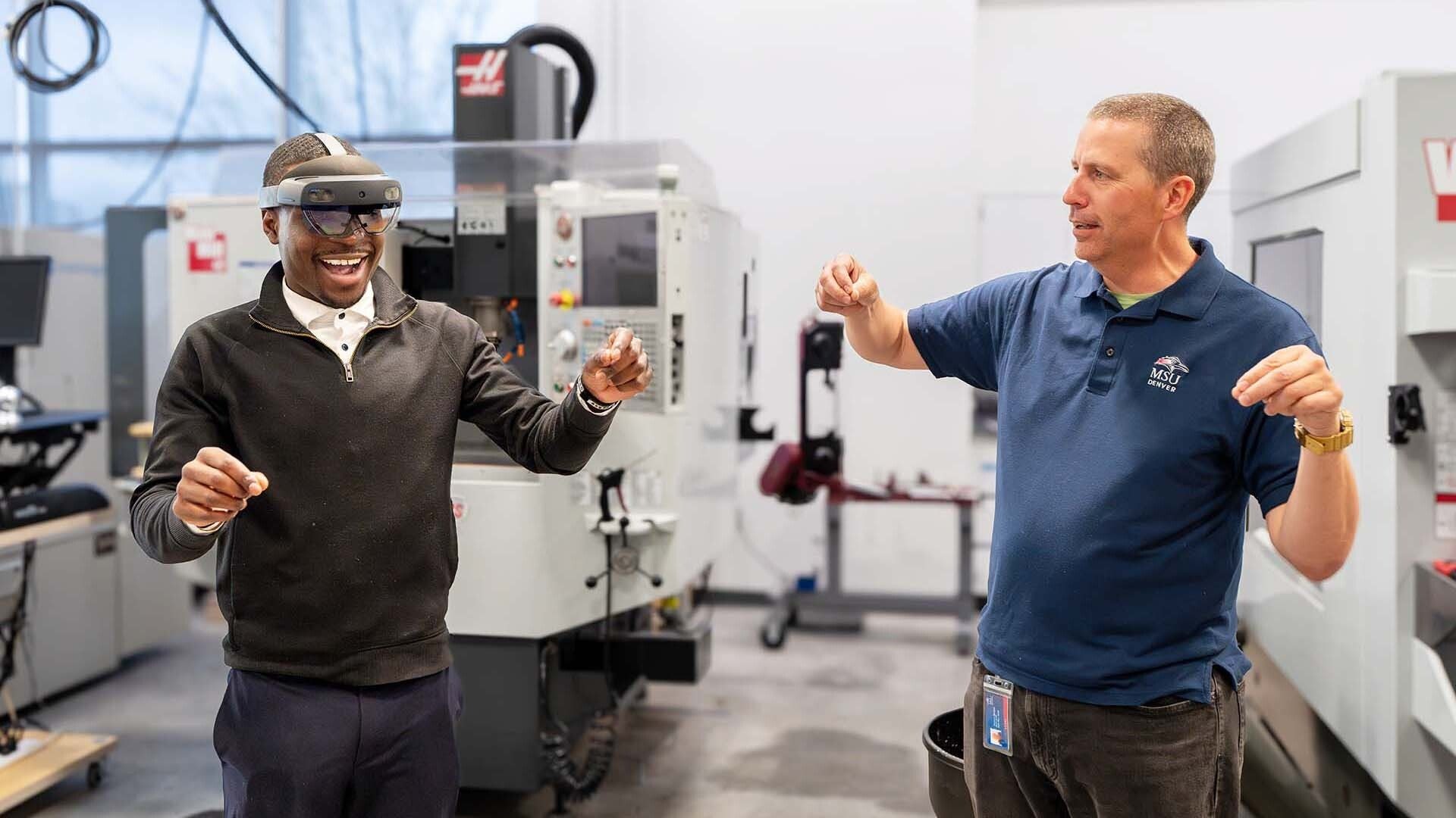 Students and instructor Stephen Morgan use augmented reality headsets to practice precision measurement skills in a training simulation.