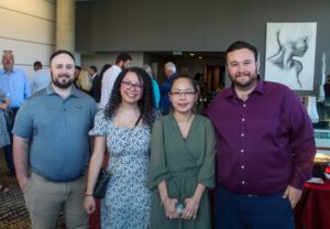 2025 Spring MBA & MPAcc Hooding Celebration - grads smiling with their family and friends before the event