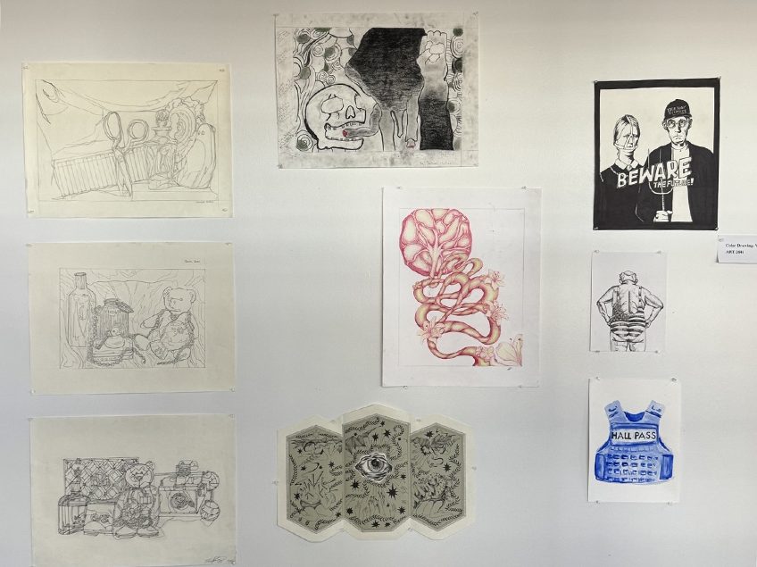 Photo of hallway collage of drawings and paintings of many varied techniques.