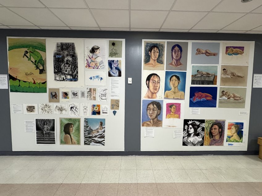 Photo of collage of drawings and paintings of many varied techniques, positioned in the main Art Department hallway.