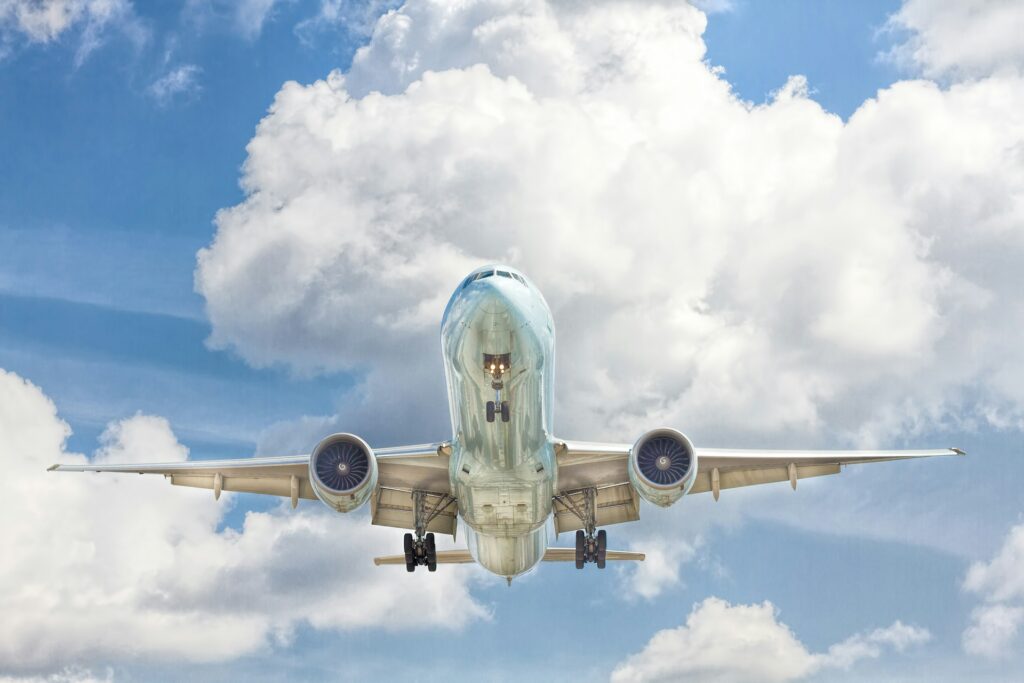 Plane flying in the sky on a cloudy day.