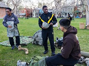 Private Walker speaks with MS1 cadet Braulio Uribe, a first-year in the program, during their sunrise ROTC training. Photo by Amanda Schwengel