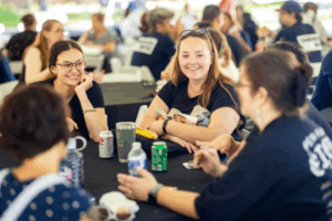 students talking and smiling while eating food