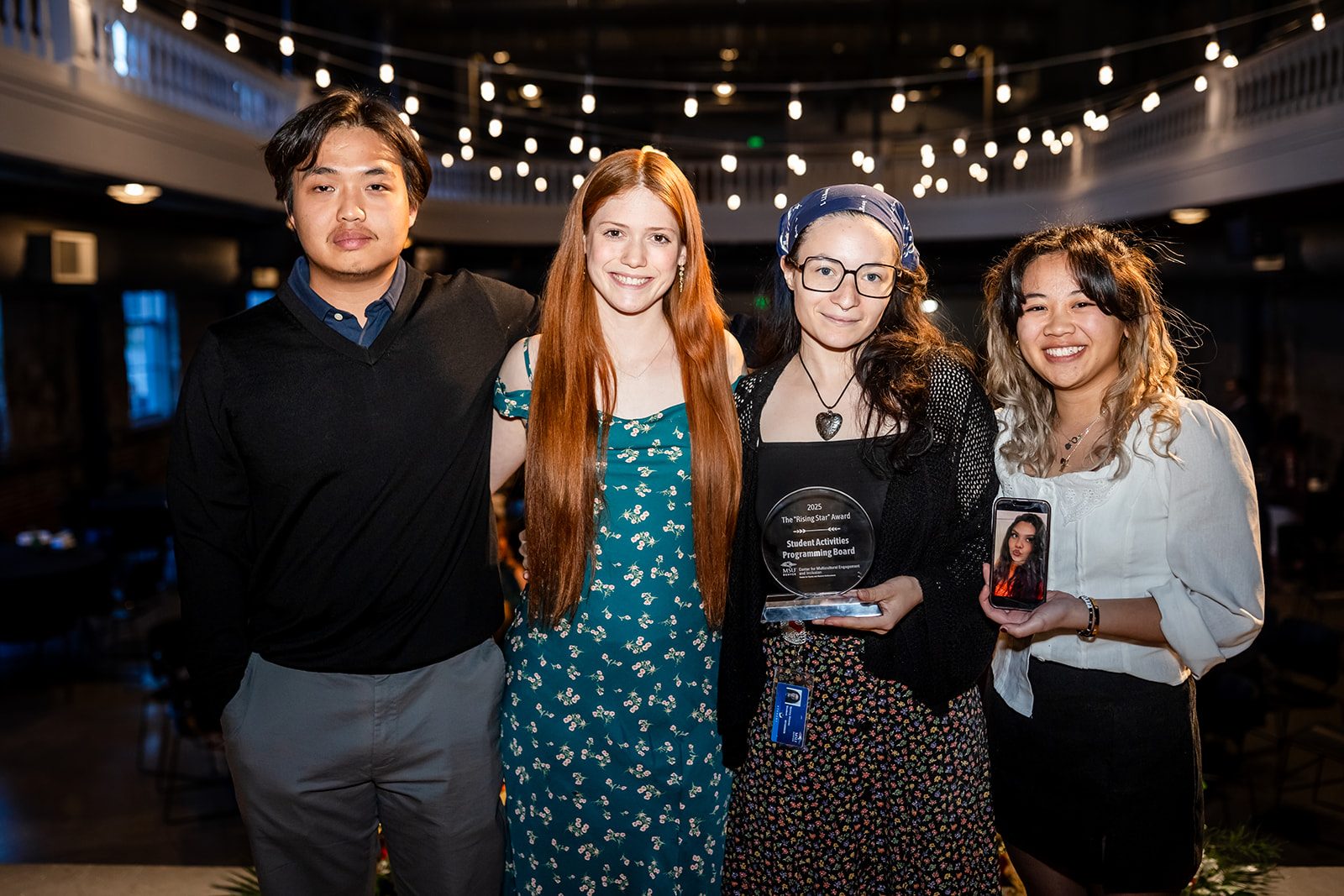 Group of students posing with an award