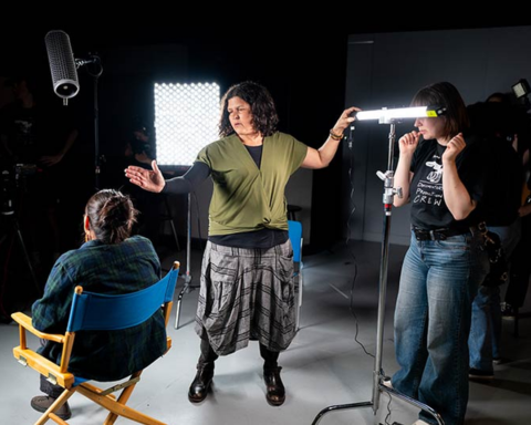 Suree Towfighnia, in MSU Denver's video production program, works with students in a production studio.
