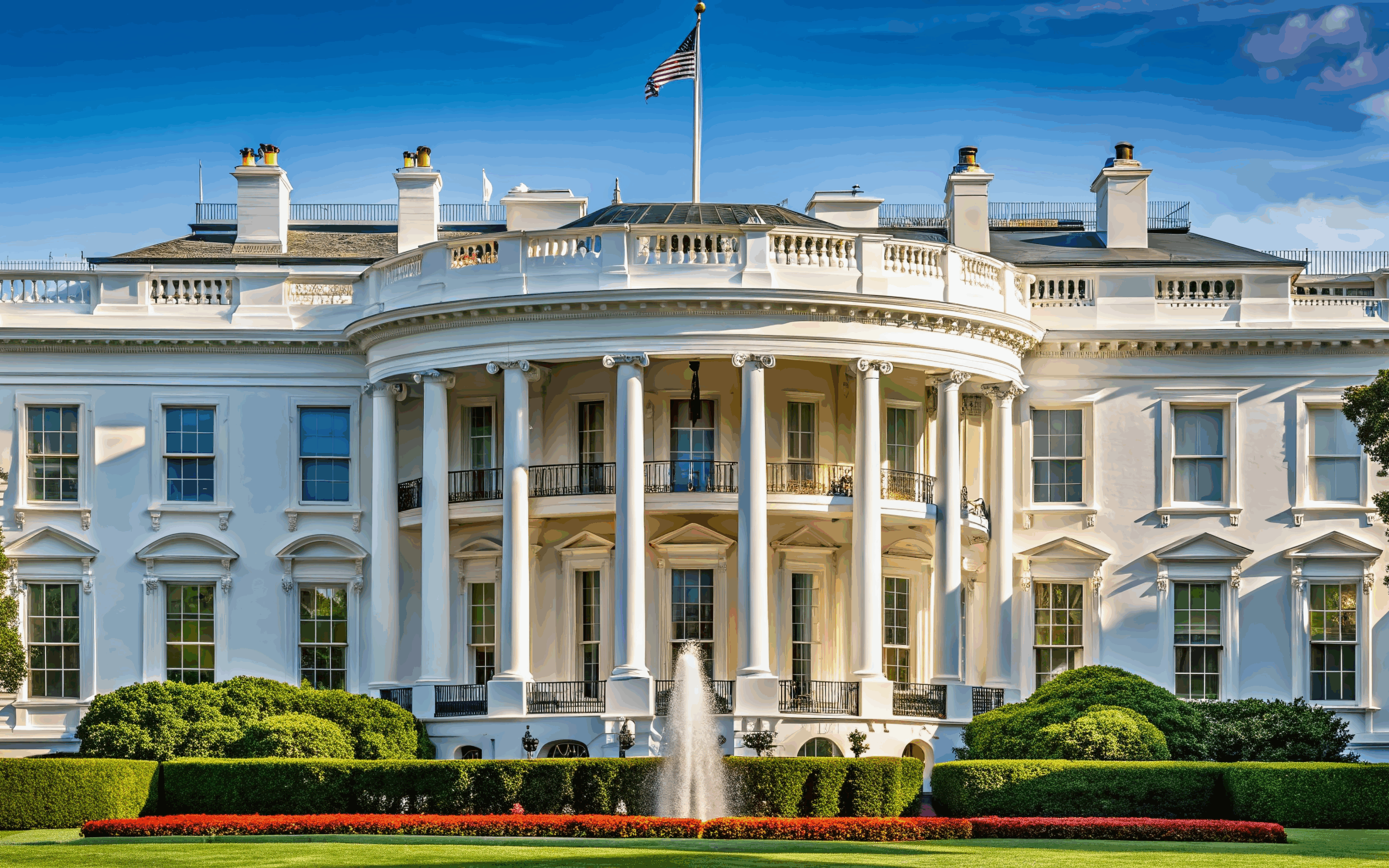 White House South Portico with fountain in front and American flag above.