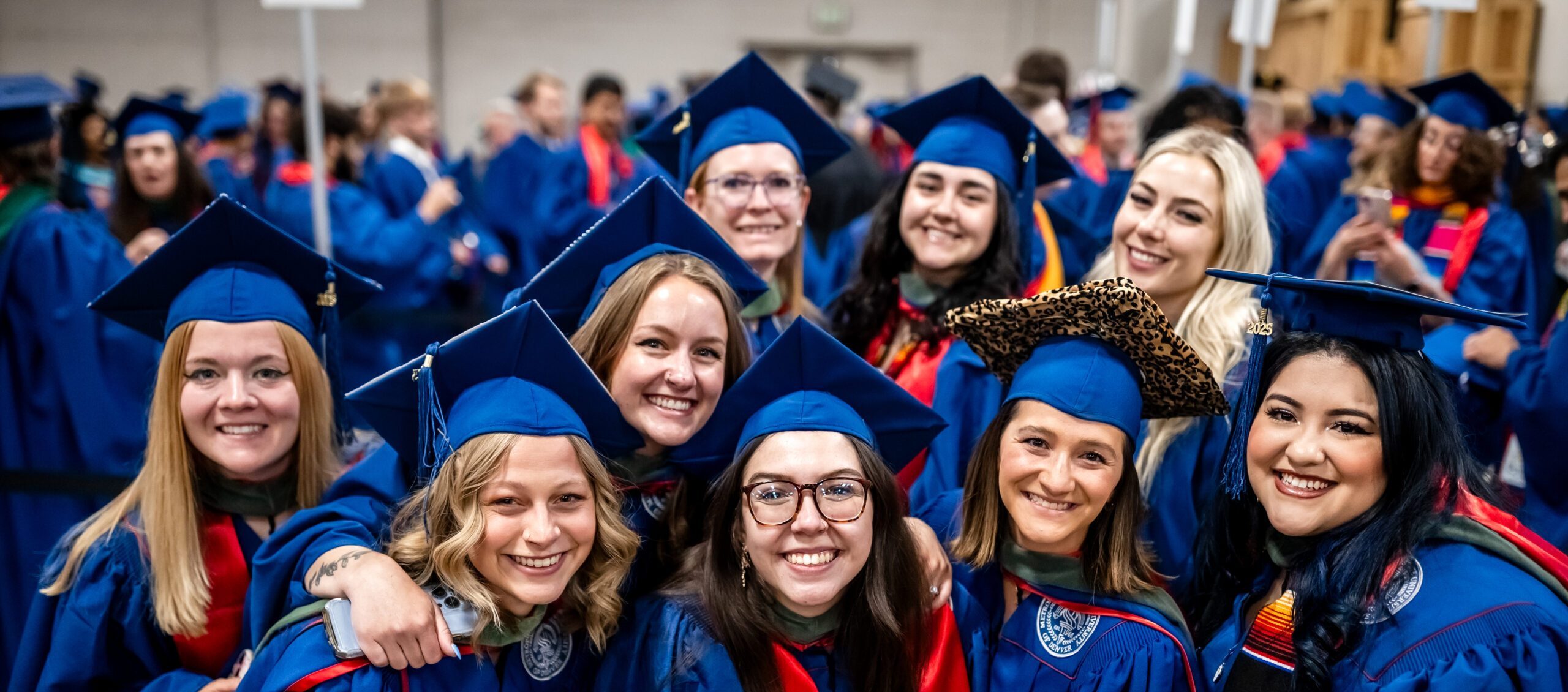 Students gather and smile for a photo before the Commencement Ceremony begins
