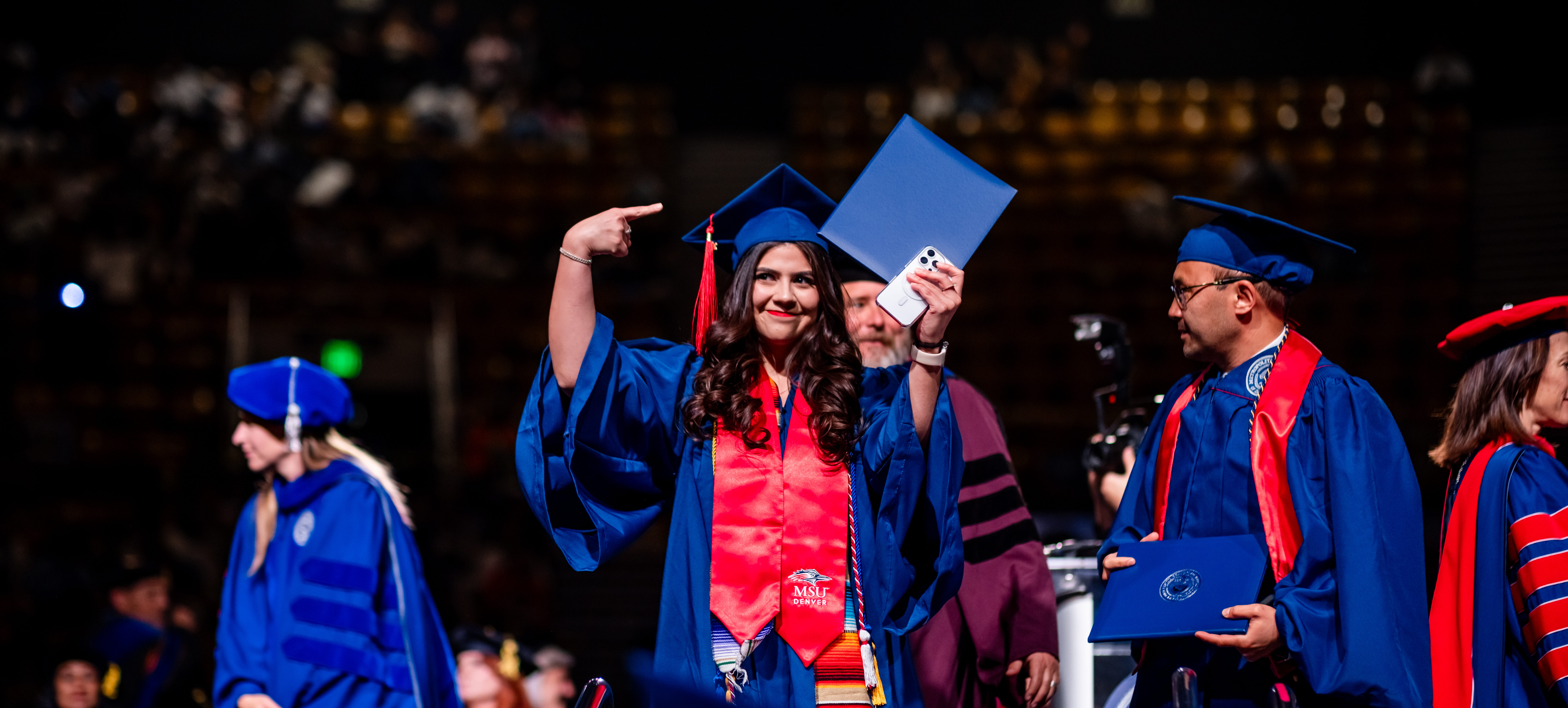Grad showing off their new diploma.