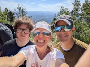 Accounting faculty, Amy, with son and husband in front of a great CO view after trekking the Manitou Incline
