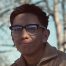 A young man with dark hair and glasses