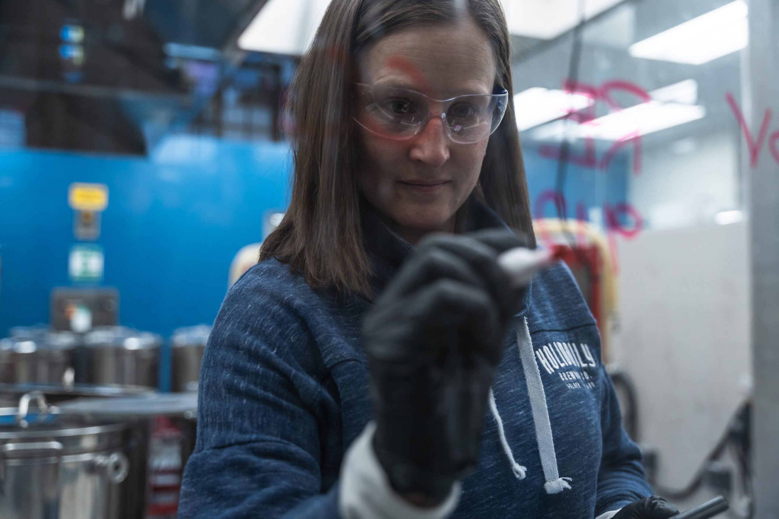 Beer student making calculations on a pane of glass with a marker