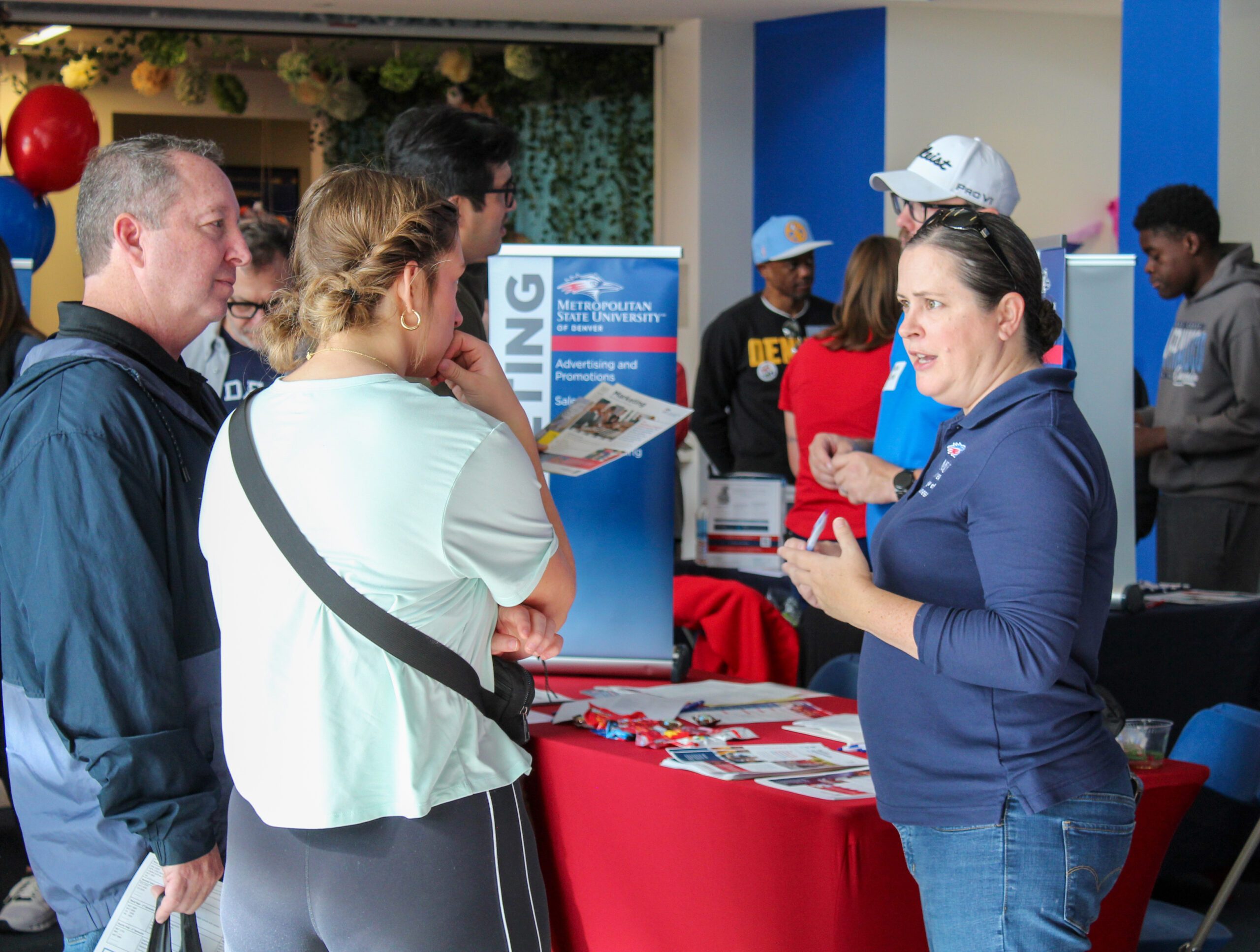 Wendy Walker, CBUS advisor, talking with students at the MSU Denver open house