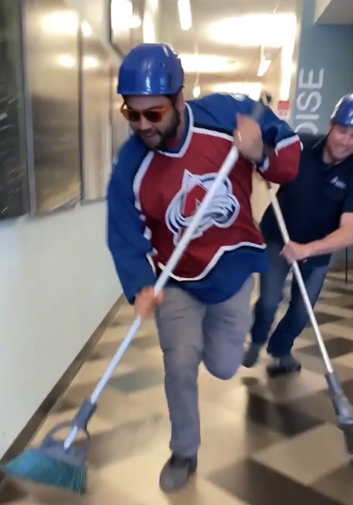 two school of hospitality staff doing a hockey skit