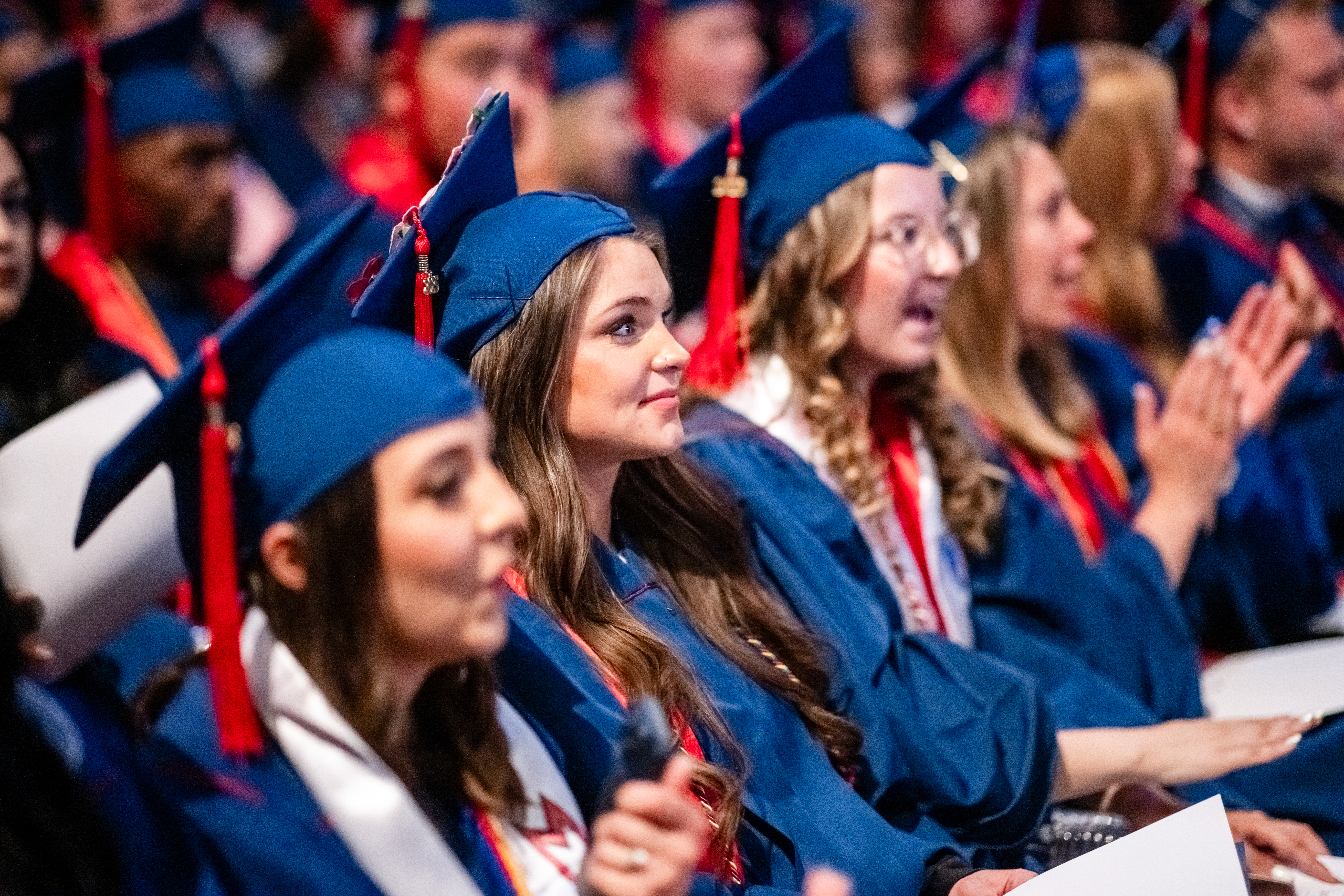 Grads watching the ceremony and clapping.