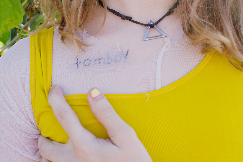 Close-up of a person wearing a yellow top with 