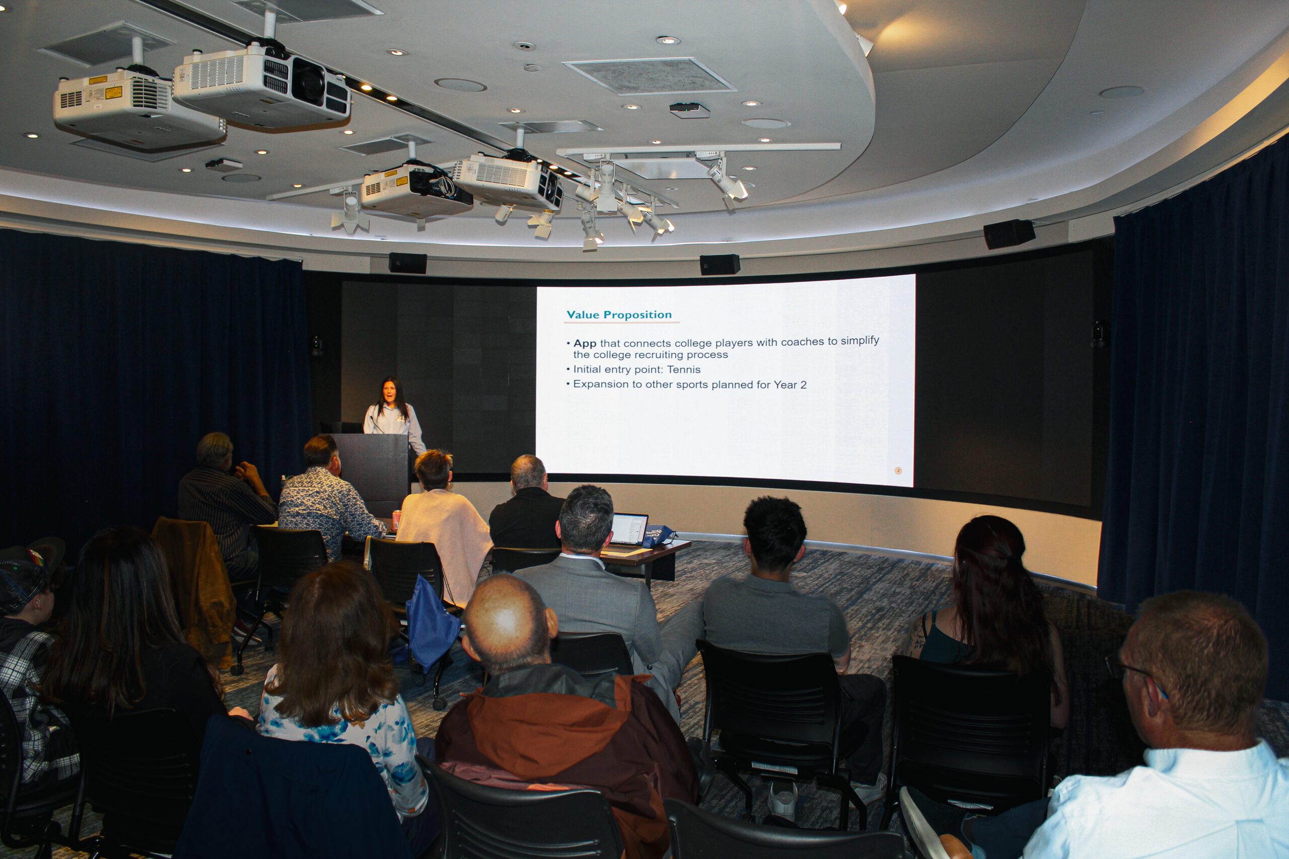 Pitch a Business Competition. Emily Hafner presenting her business pitch.