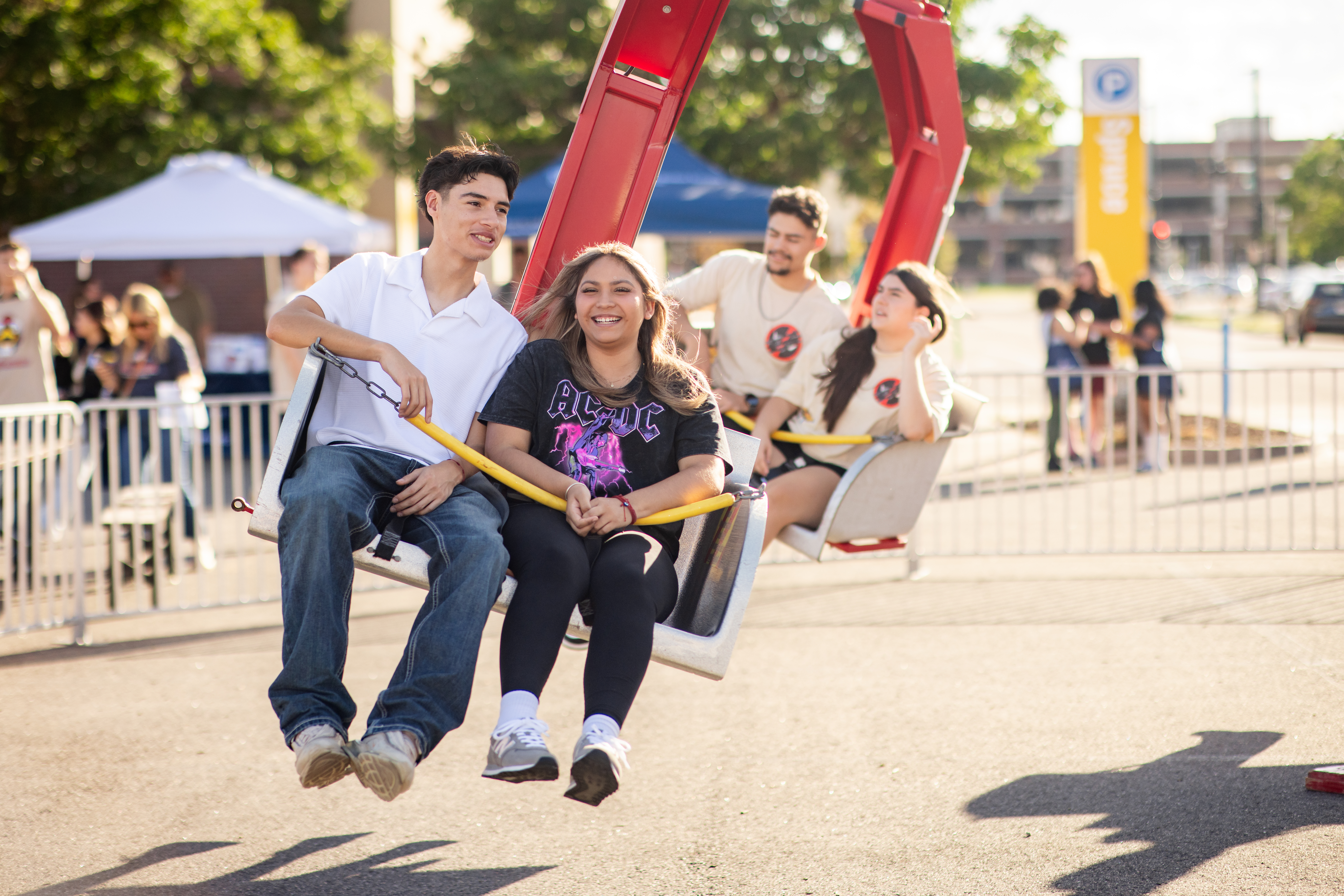 Student riding a carnival attraction.