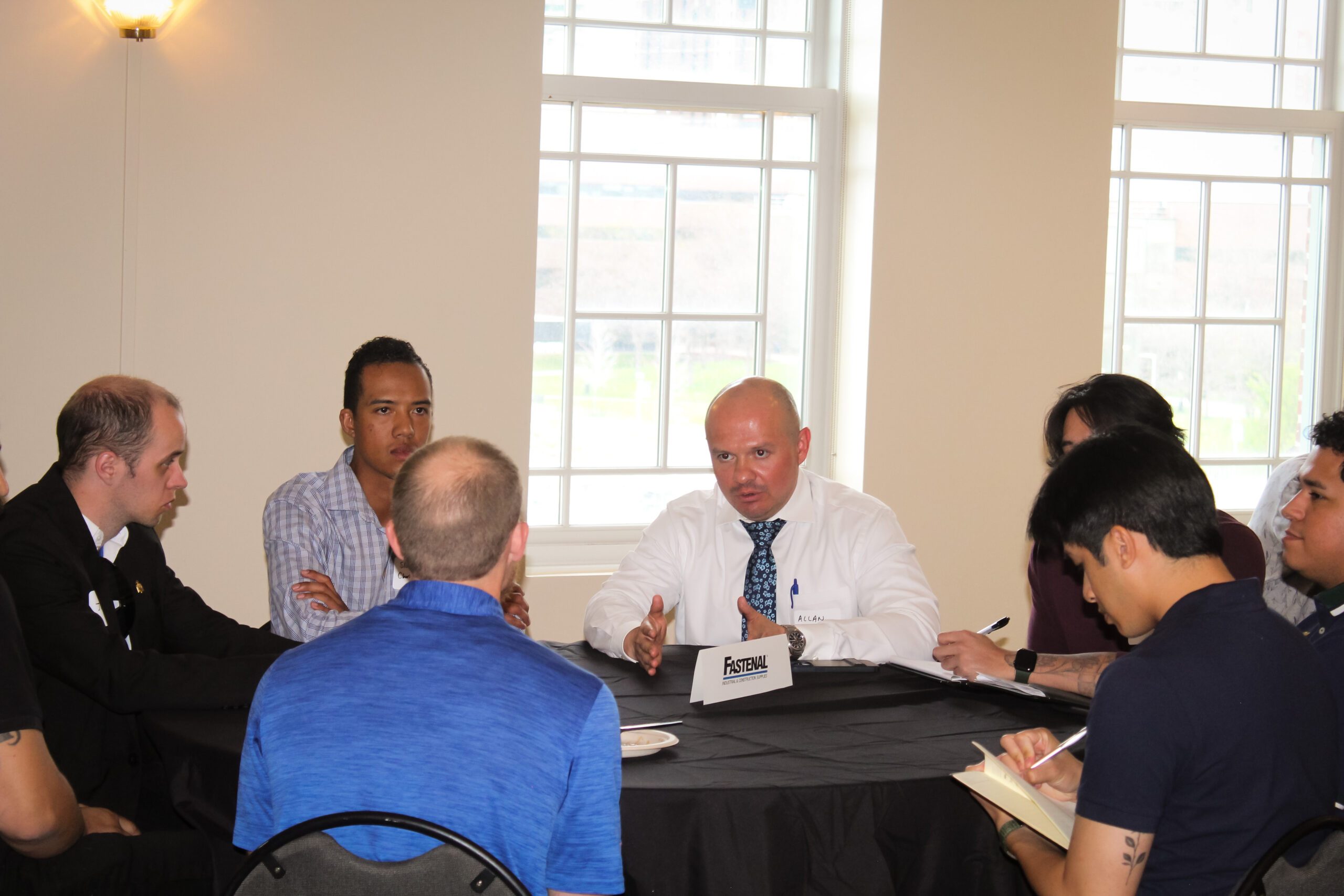 Fastenal staff talking with students.