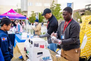 Two members of the MSU Denver Greek community serving snow cones. 