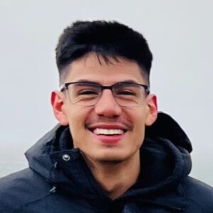 A young man with short black hair and glasses