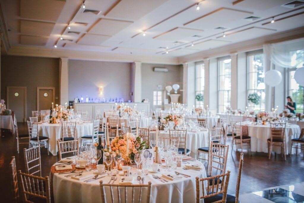 A wedding venue with tables and decorations in a dining area.