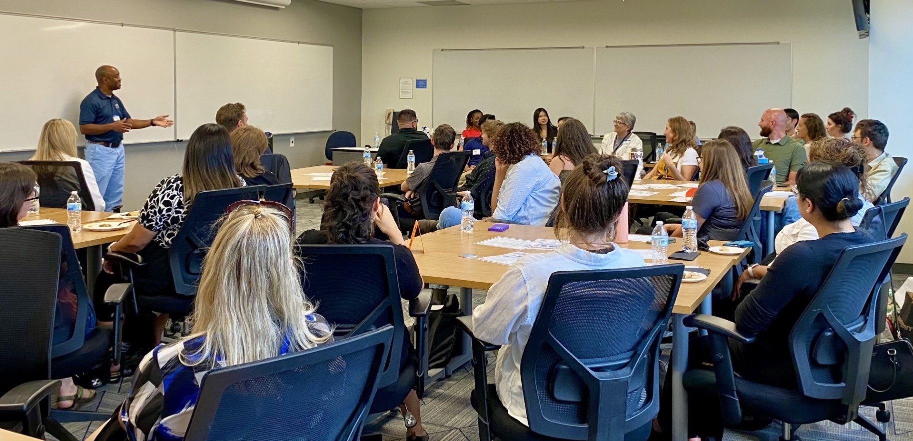 A photo from our Fall 2025 MPAcc Orientation _ full classroom shot from back of room with MPAcc Director standing at front