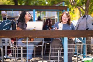 Two MSU Denver students studying outdoors on a patio