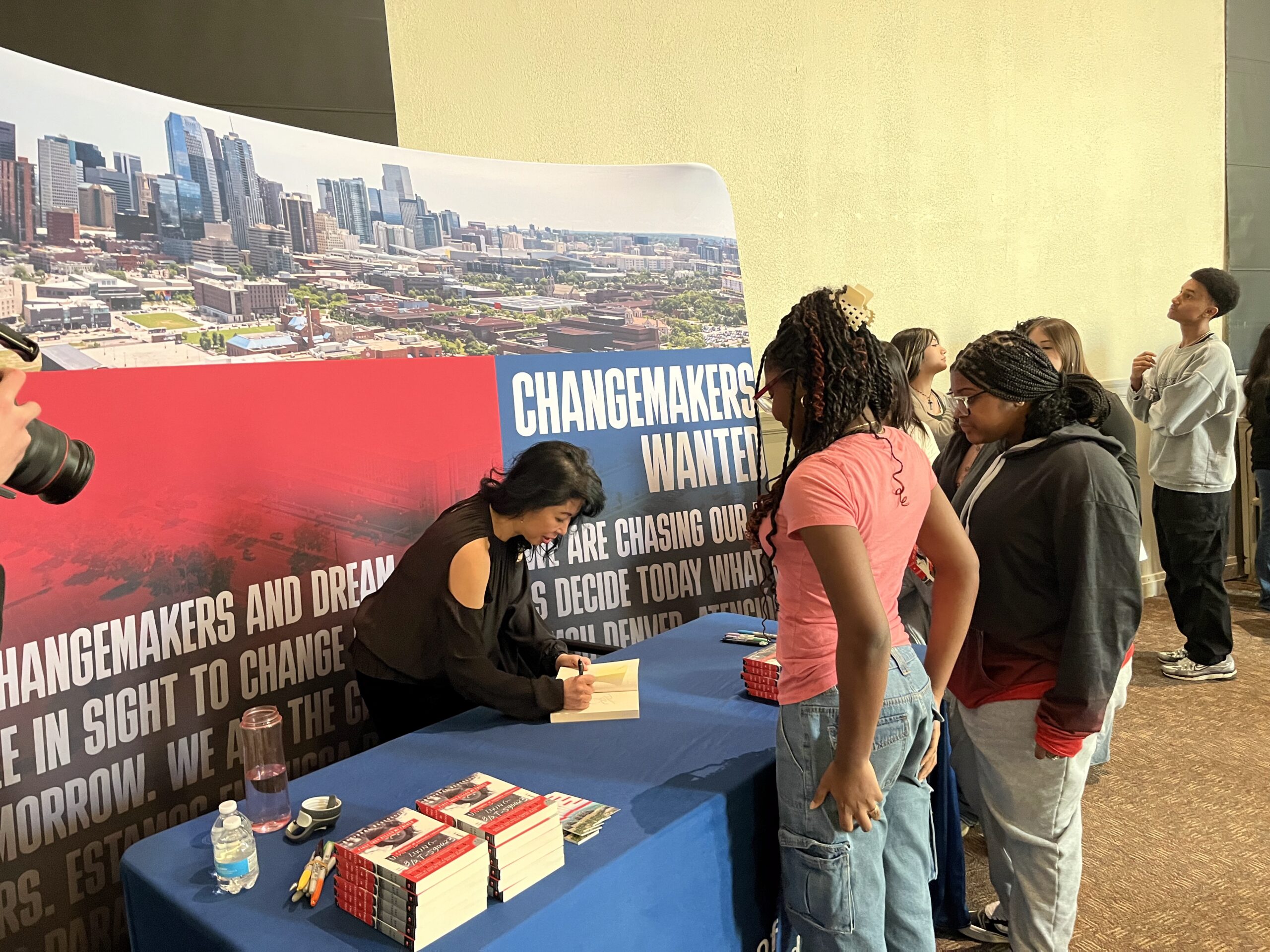 Author Loung Ung signing books for students
