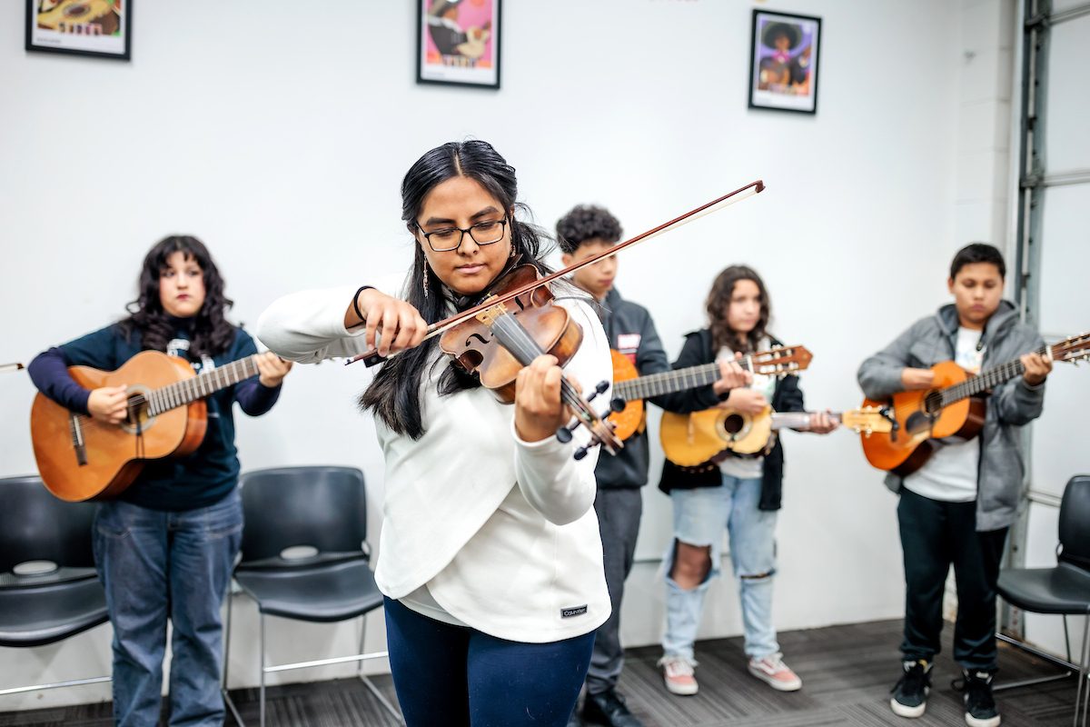 MSU Denver alumna and Director of Colorado Youth Mariachi Program practices with her students during class.