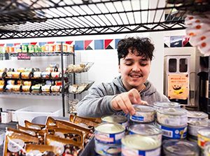 MSU Denver student and Rowdy’s Corner employee Alejandro Ramirez stocks shelves at Rowdy’s Corner. Photo by Amanda Schwengel