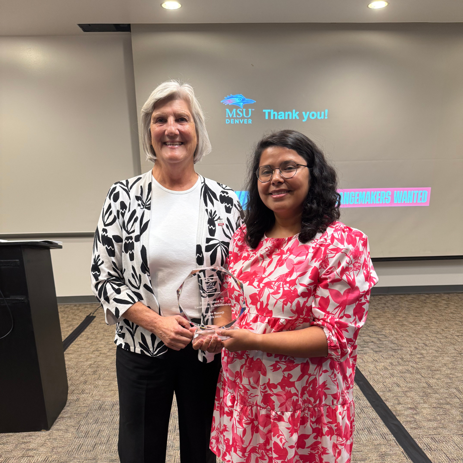 Dean Murphy and Devika Banerji posing with their College of Business Deans Awards