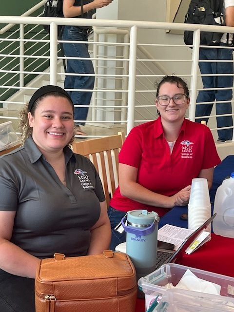 A photo of Clare Fidler and Brianny Morrison tabling in the Admin Lobby