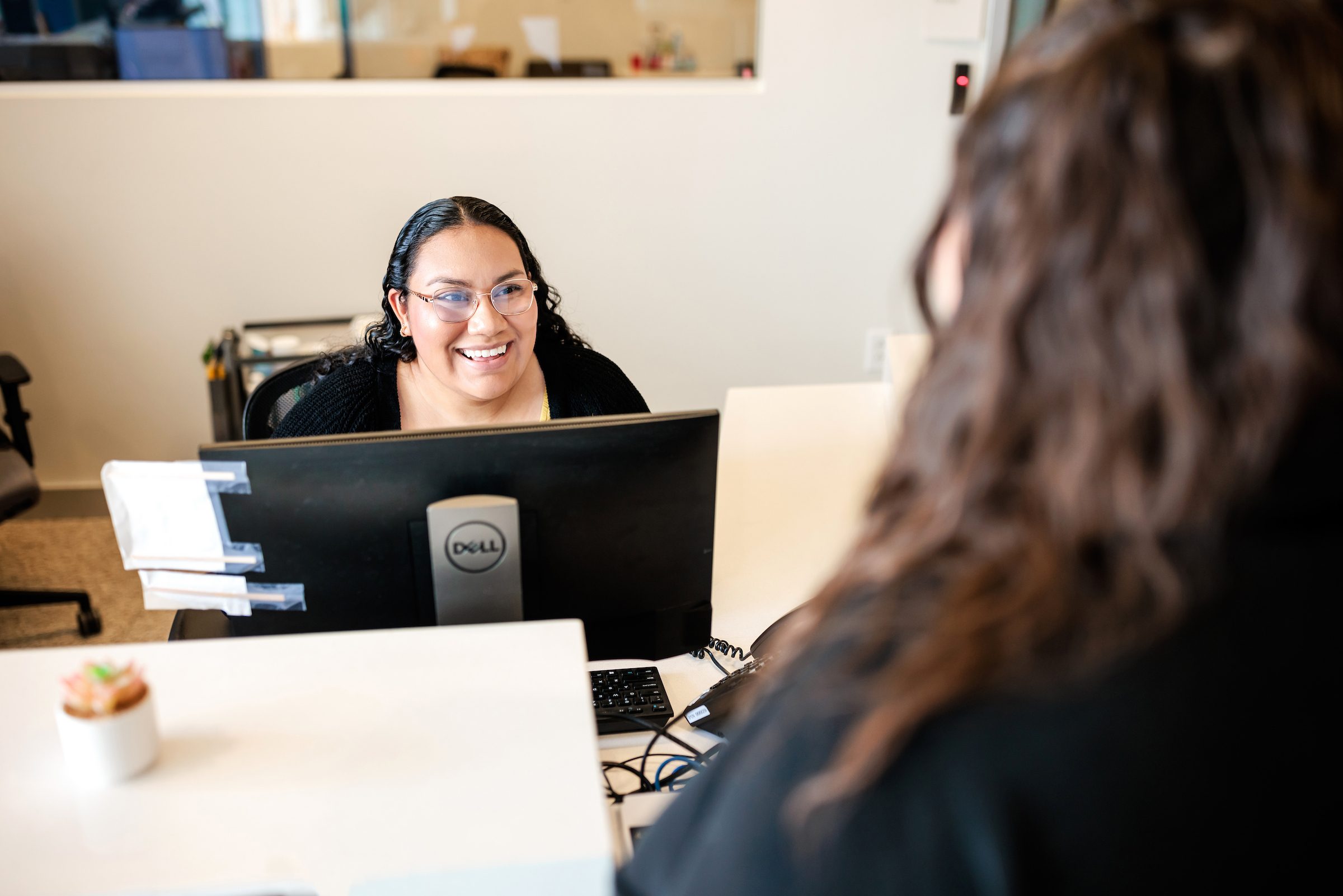 Student smiling helping talking to another