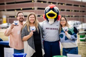 College of Business marketing team taking a picture with Rowdy on the Day of Giving