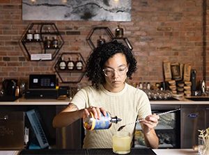 MSU Denver hospitality student Ari Vera Rivera makes a cocktail at Method & Muse in Olde Town Arvada.